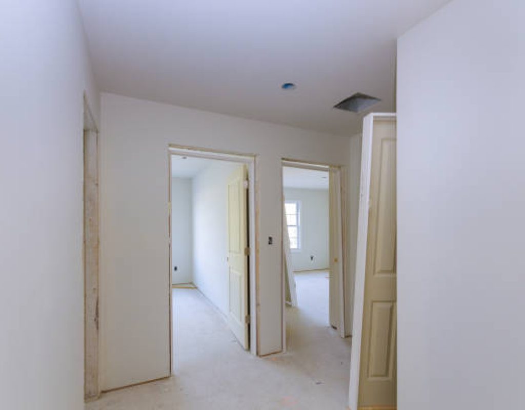 Technician installing a secure entry door on a Middleton, WI suburban home during daylight