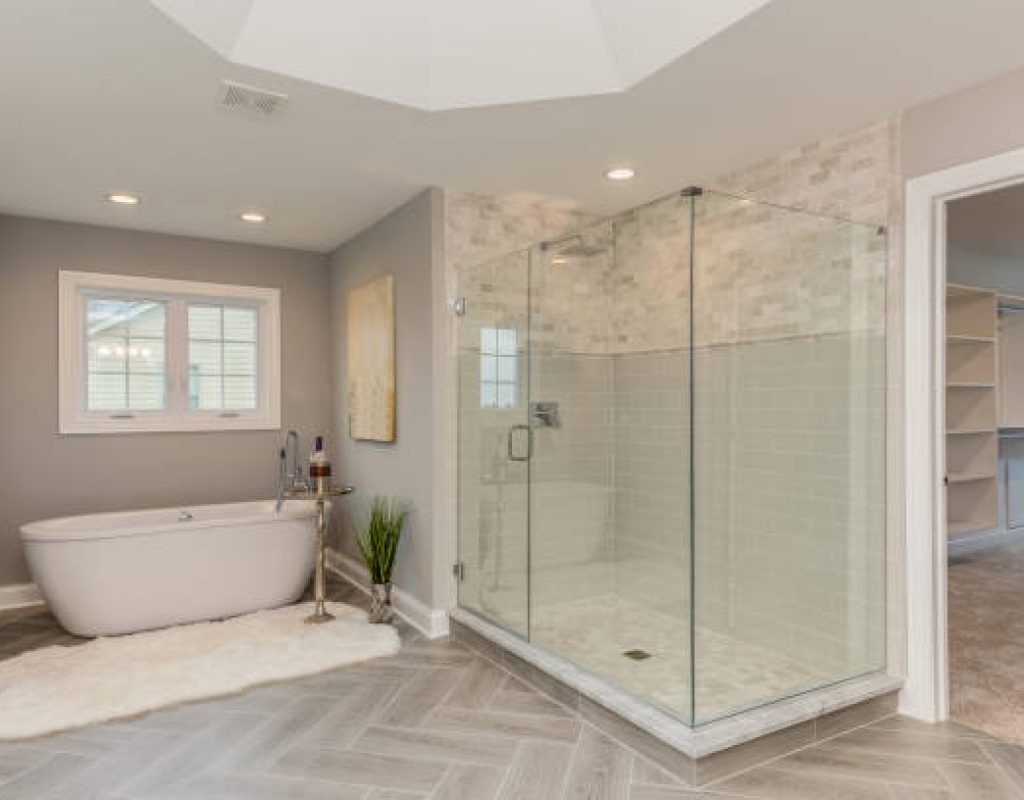 Designer and homeowner reviewing custom tile samples for a luxury bathroom remodel in Fitchburg, WI