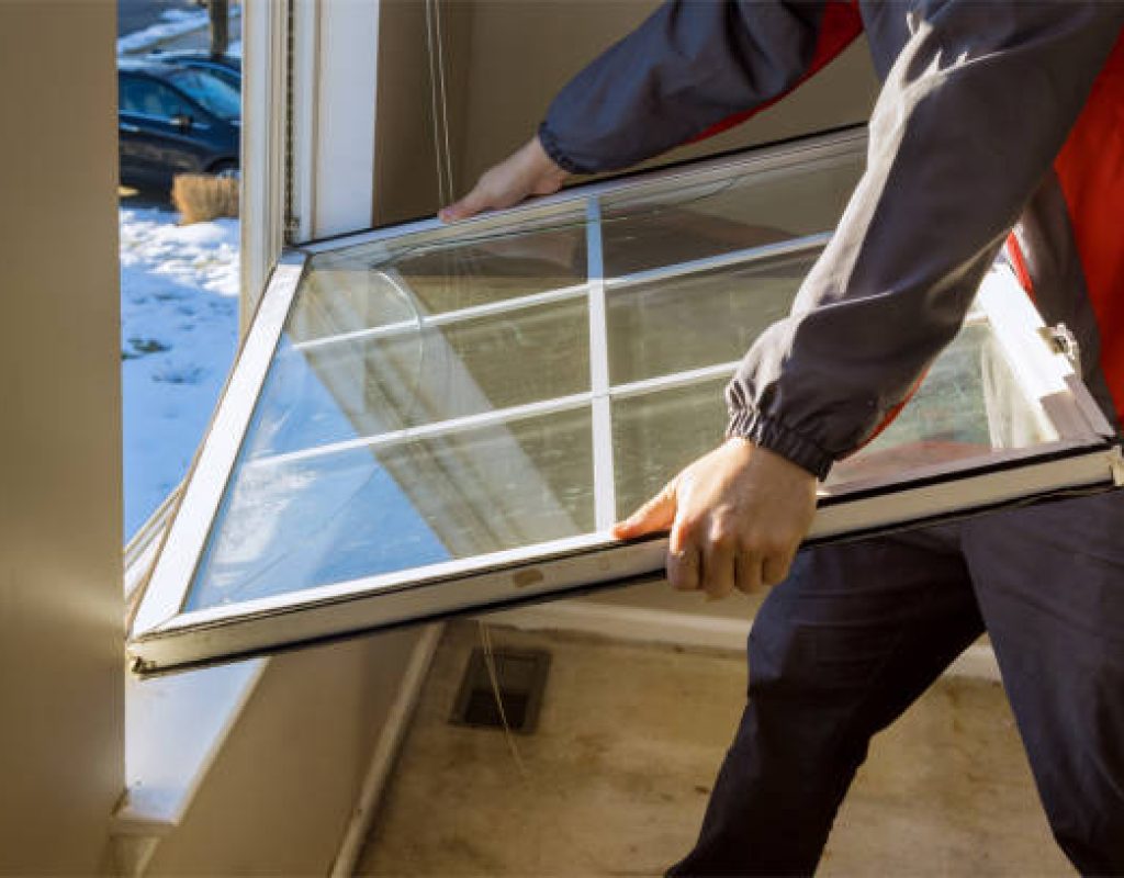 Skilled installer sealing new triple-pane window with precision tools in Waunakee, WI