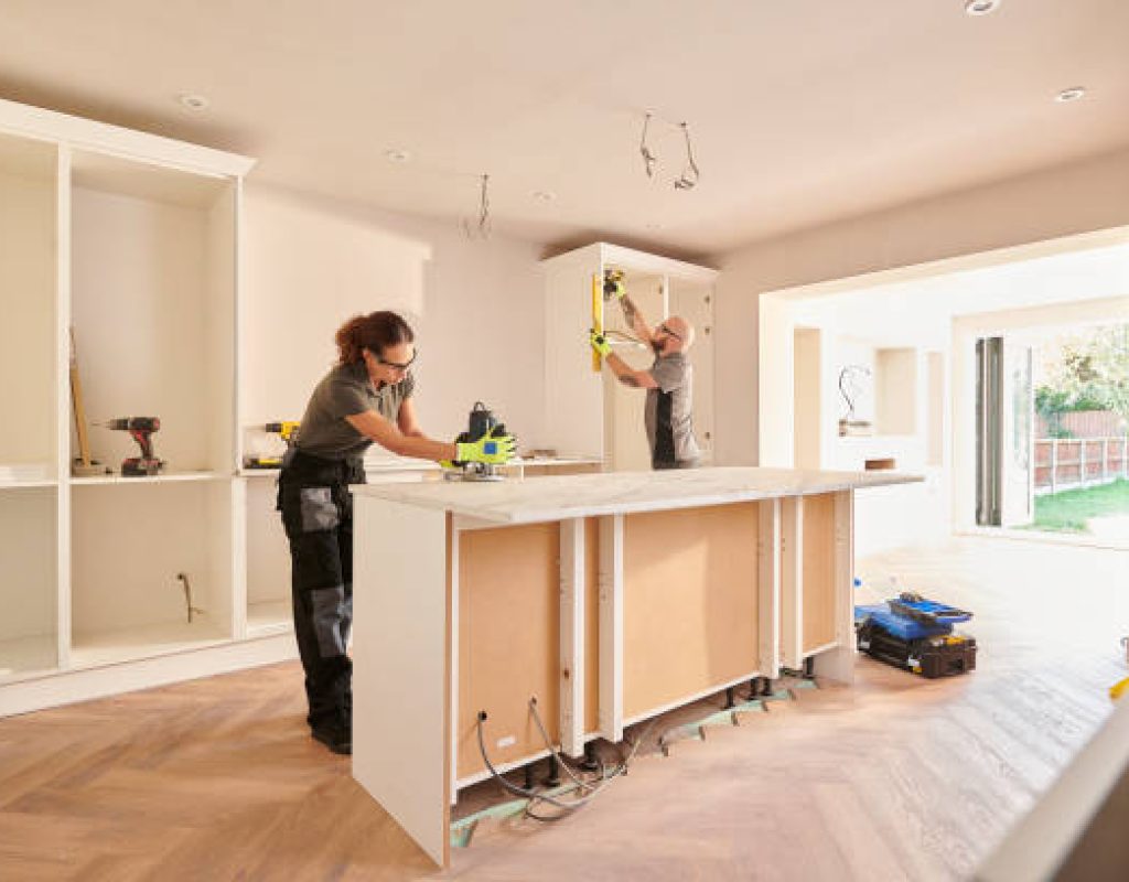 Experienced remodeler reviewing kitchen blueprints and material samples for Madison, WI upgrade
