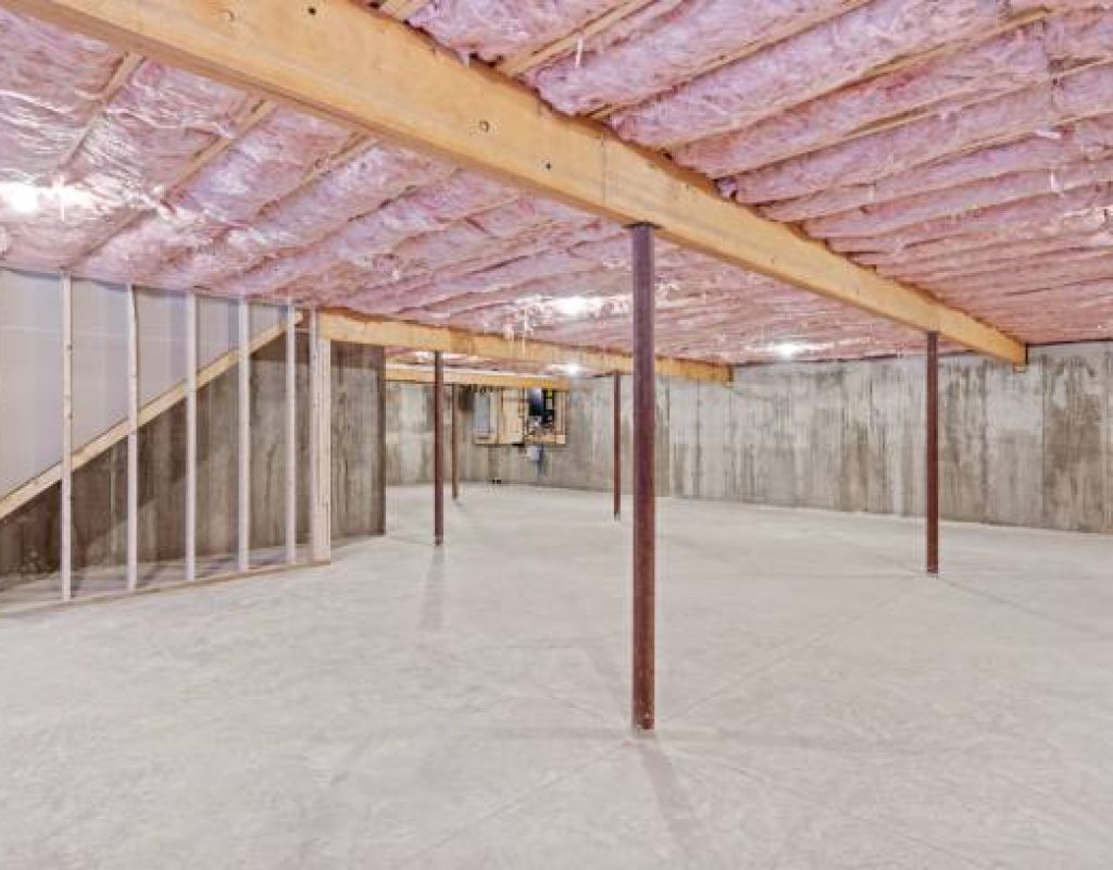 Skilled remodeler reviewing basement layout, framing, and finish details before construction