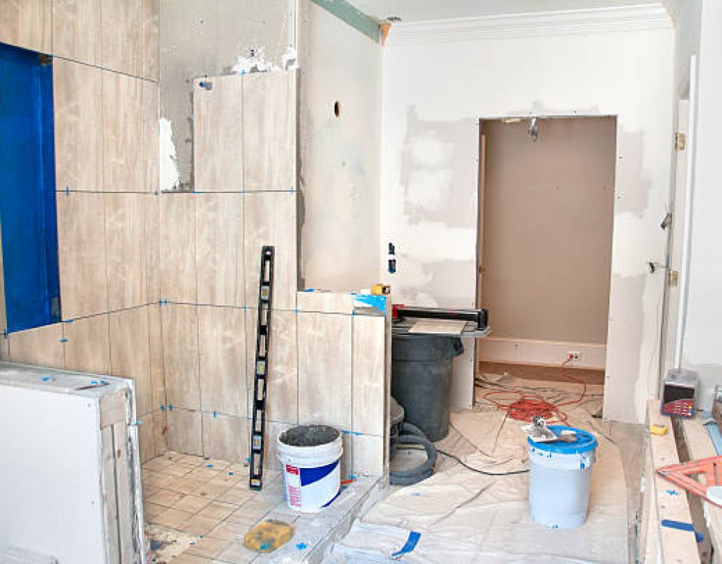 HLW BUILDERS, LLC installing modern vanity and lighting in bathroom renovation