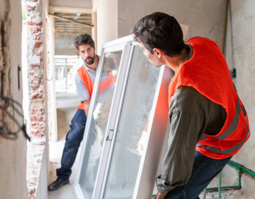 Skilled installer using precision tools to fit new energy-efficient window in Madison, WI