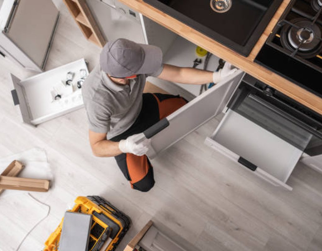 HLW BUILDERS, LLC installing kitchen cabinets and countertops in modern home