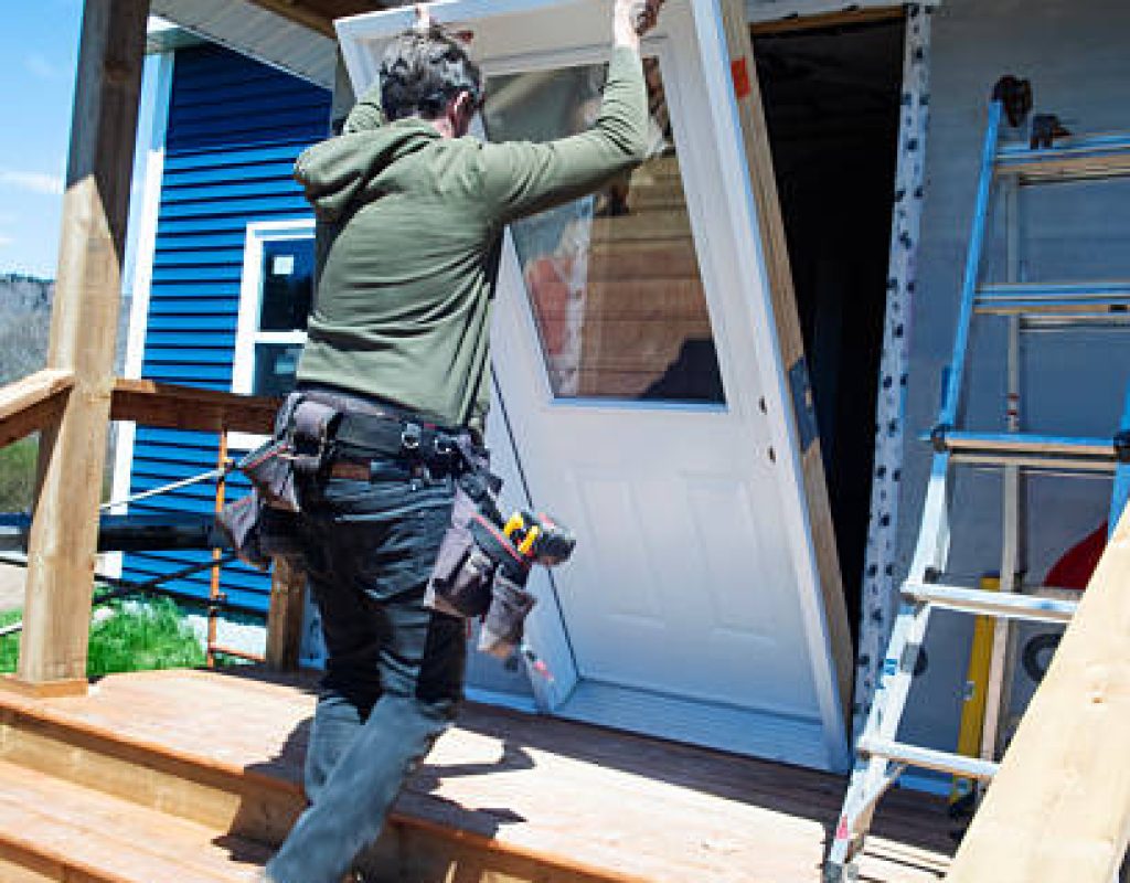 HLW BUILDERS, LLC installing sturdy residential front door with modern frame